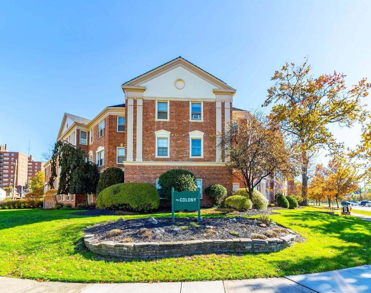 A smaller brick apartment building among autumn trees in Cleveland Heights.
